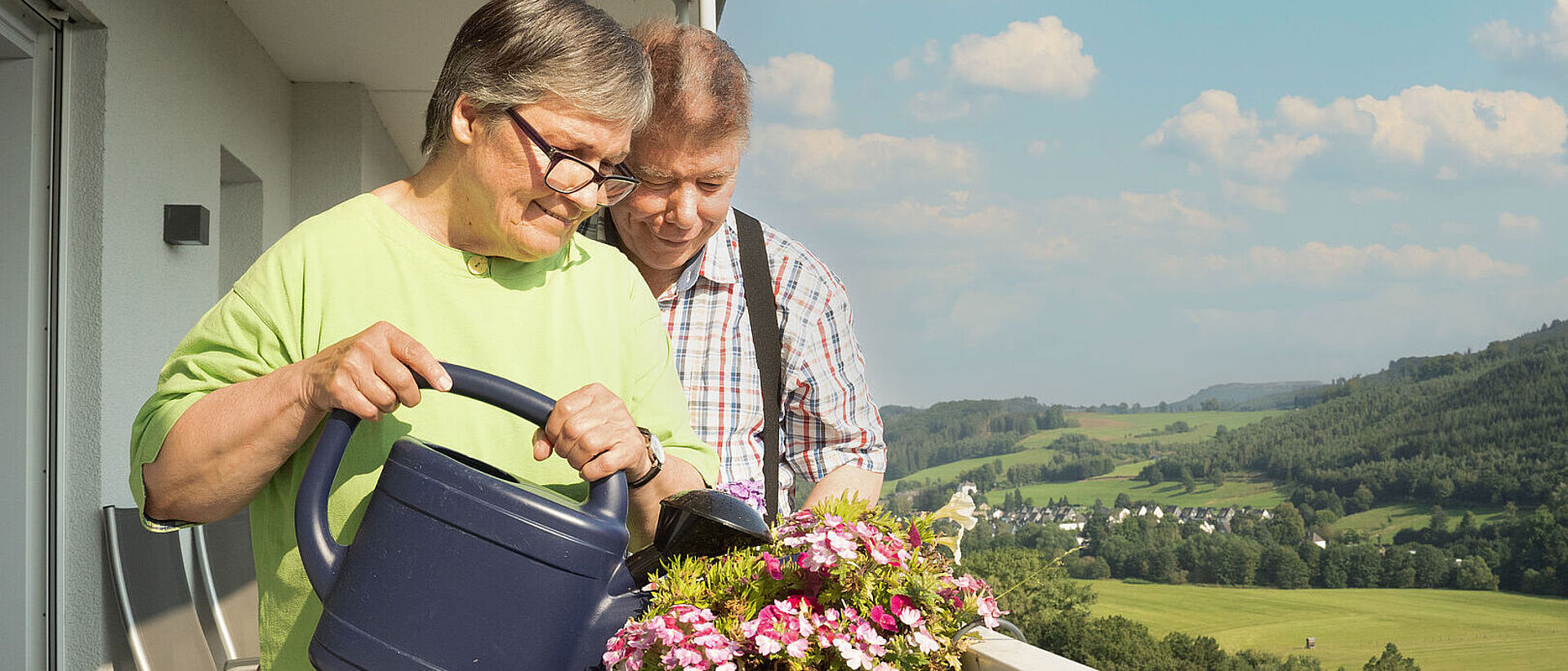 Balkon Wohngemeinschaft "Ruhrtalblick" Senioren gießen Blumen auf dem Balkon. Szene: DRK-Wohngemeinschaft "Ruhrtalblick"